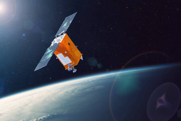 istock Space satellite orbiting Earth low polar orbit. Bright light from the sun and glare in the frame. Elements of this image furnished by NASA. 1171992815