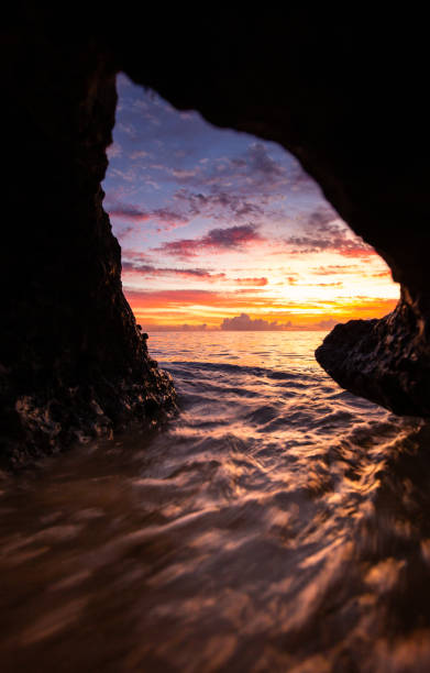 istock A stunning sunset through an ocean cave hole 1171995473
