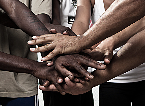 Closeup portrait of group with mixed race people with hands together