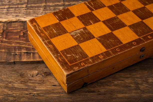 istock Old chessboard on a wooden background 1171999976