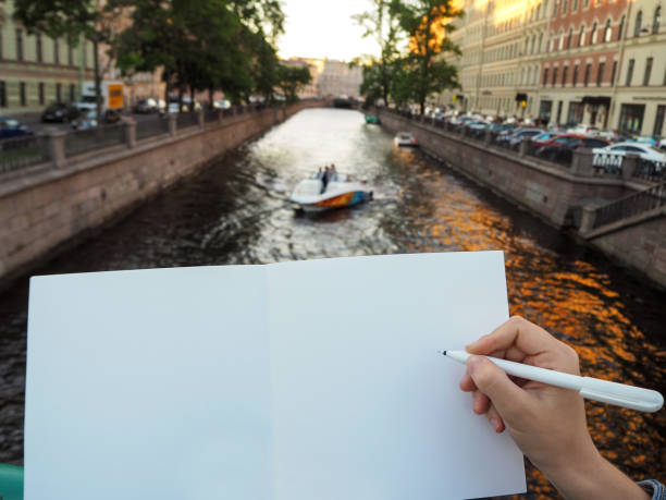 istock Mockup of person's hand holding blank white notebook preparing to write down his or hers ideas. 1172002286
