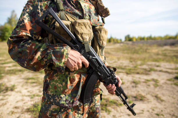 istock Soldier holds a machine gun in hands, close-up 1172002340