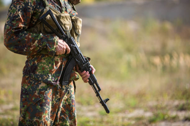 istock Soldier holds a rifle in hands, close-up. 1172002371