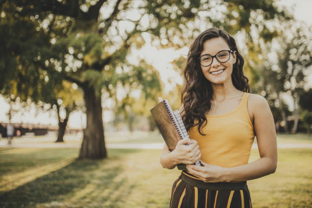 公園の学生の女の子 - nature smiling teenage girls female ストックフォトと画像