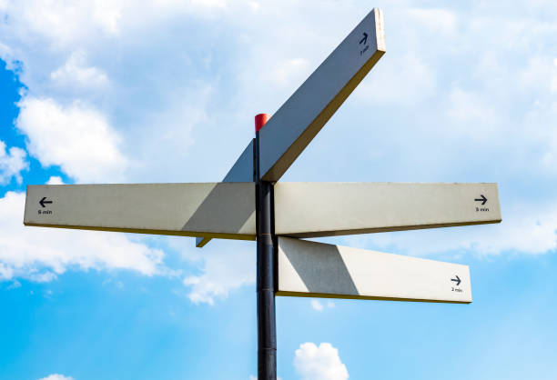 istock Blank signpost with many directions against blue sky in sunny day. Mockup 1172006308