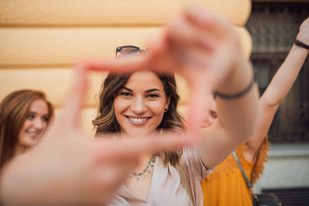 istock Smiling woman framing face on street 1172007464