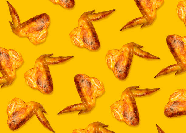 Colorful pattern of chicken wings roasted on bbq. Yellow background
