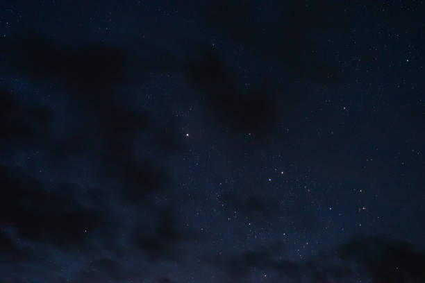 istock Stars in the night sky through the clouds 1172012130
