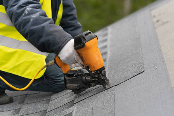 istock Workman using pneumatic nail gun install tile on roof of new house under construction 1172013105