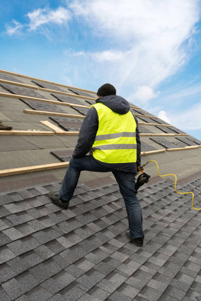 istock Workman using pneumatic nail gun install tile on roof of new house under construction 1172013474