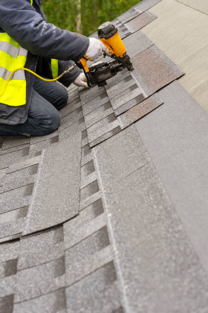 istock Workman using pneumatic nail gun install tile on roof of new house under construction 1172013686