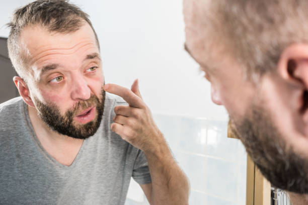 istock Man looking at wrinkles on his face 1172014852