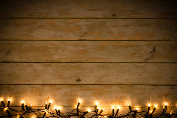 istock Empty rustic wooden table with Christmas lights at the bottom border 1172015024