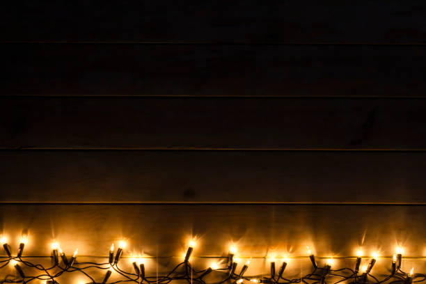 istock Empty rustic wooden table with Christmas lights at the bottom border 1172015034
