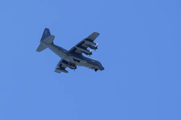 istock grey military transport plane fly on blue sky background 1172016031