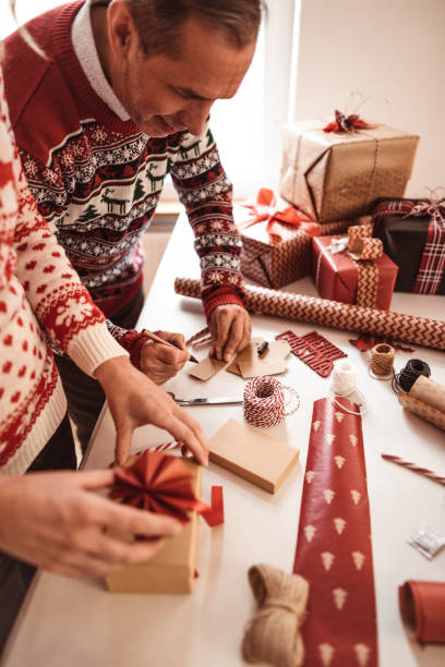istock couple preparing christmas presents 1172019555