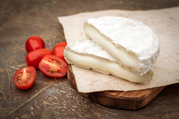 istock Tasty cheese with white mold on the cutting board. Sliced 