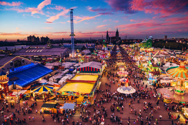 Munich, Germany - September 29, 2016: Visitors Walking Through Oktoberfest Fairgrounds, aerial view at dusk.