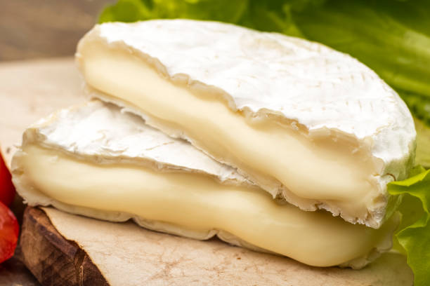 istock Two pieces of cheese with white mold. The brie cheese 1172020557