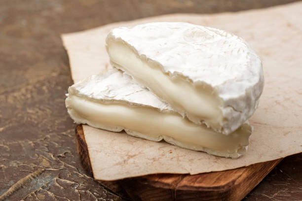 istock two pieces of tasty white mold cheese on a cutting board 1172020616