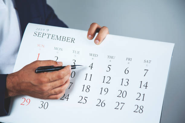 istock business man  hand pen with calendar 1172022905