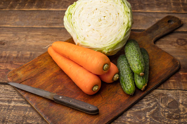 Assorted fresh vegetables on a wooden cutting board. Ingredients for making vegetarian salad
