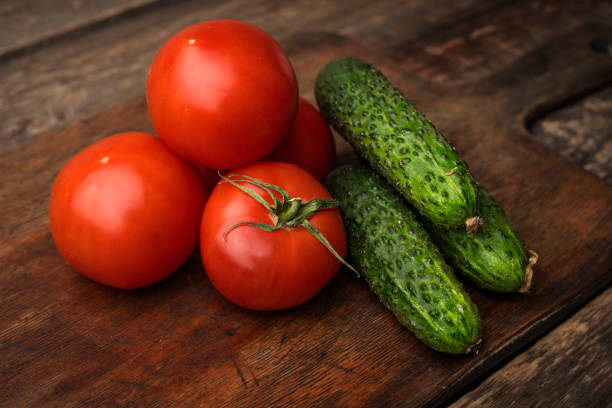 istock Fresh vegetables cucumbers and tomatoes on the kitchen table 1172024428