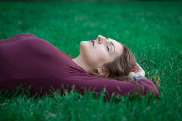 istock Young woman laying in a grass 1172025465