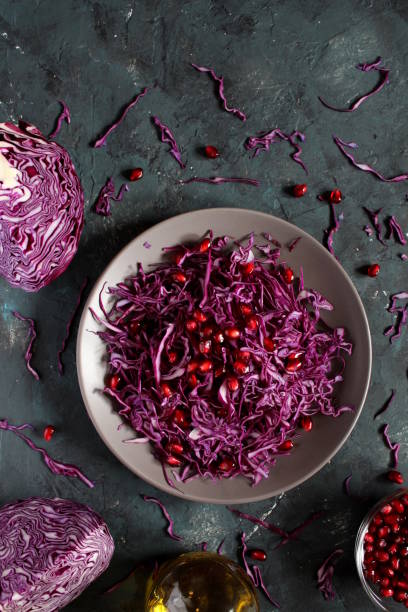 istock Red cabbage salad with pomegranate on dark background. 1172026866