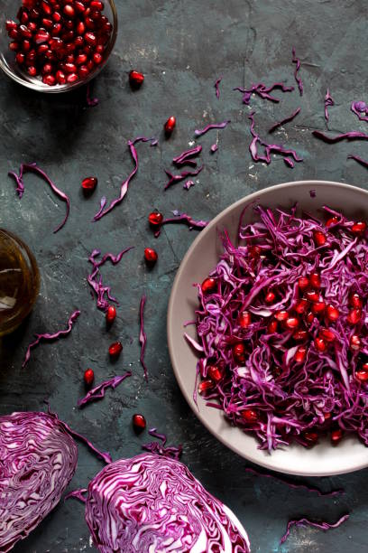 istock Red cabbage salad with pomegranate on dark background. 1172027011