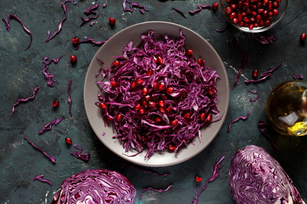 istock Red cabbage salad with pomegranate on dark background. 1172027259