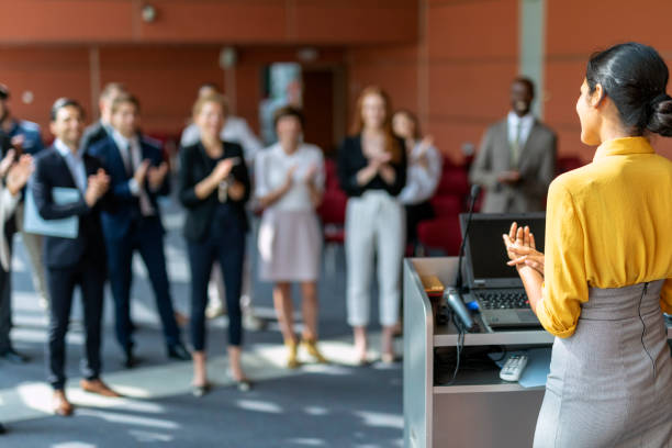 Successful presentation Audience applauding an Indian female presenter at a business presentation in the board room woman press conference stock pictures, royalty-free photos & images