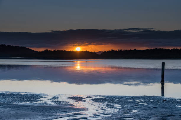 istock Sunrise and Low Cloud Bank Reflections Waterscape 1172052171