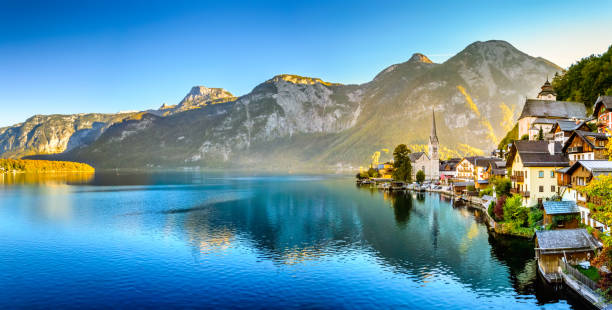 Hallstatt, Austria. Picturesque town on alpine lake Hallstatter See in Austrian Alps mountains. Autumn season. Hallstatt, Austria. Picturesque town on alpine lake Hallstatter See in Austrian Alps mountains. Autumn season. Fantastic postcard view. Famous tourist destination for vacation, hiking and relaxation. dachstein mountains photos stock pictures, royalty-free photos & images