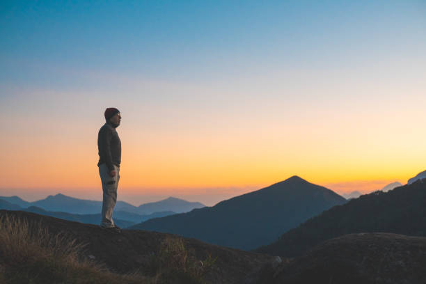 istock Man walking in the mountains during sunrise 1172068131