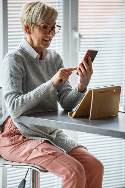 istock Mature woman using smart phone 1172072486