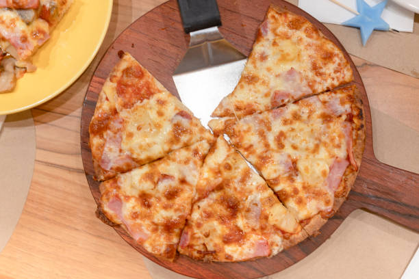 istock Pizza placed on a wooden tray 1172072781