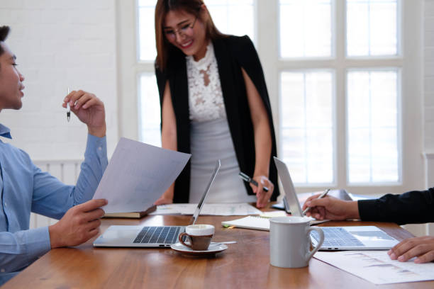 istock businesswoman analyzing discussing business project with colleague 1172074142
