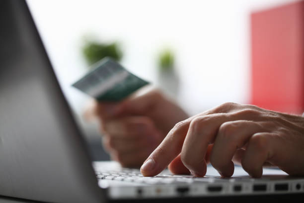 istock Male arms hold credit card press buttons making 1172074176