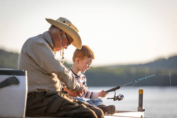grandfather and grandson fishing at sunset in summer - 6720 imagens e fotografias de stock