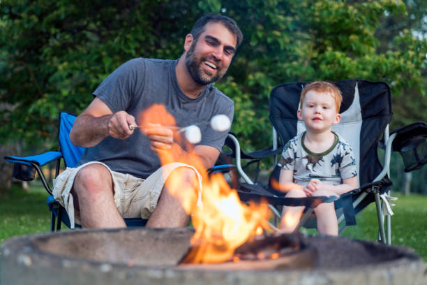 istock Father and Son Roasting Marshmallow over Campfire in Camping in Summer 1172076311