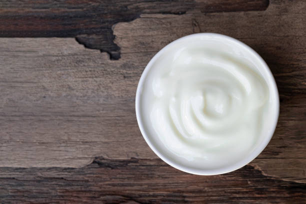 istock Yogurt  In white glass on  wood background from top view. 1172079545