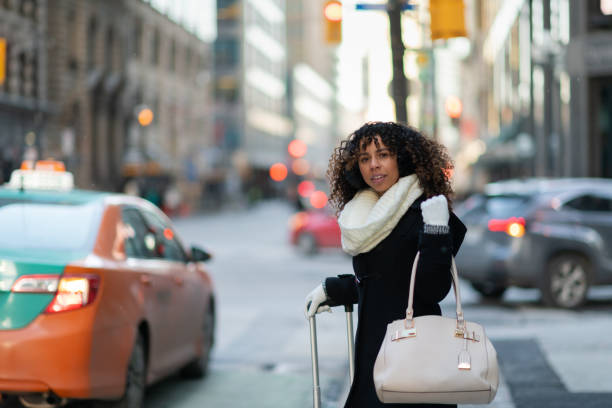Woman on sidewalk waits for her ride