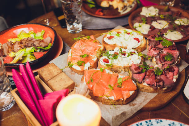 istock Appetizers table with italian antipasti snacks and wine in glasses. Brushetta or authentic traditional spanish tapas set, cheese variety board over grey concrete background. Top view, flat lay. 1172084731
