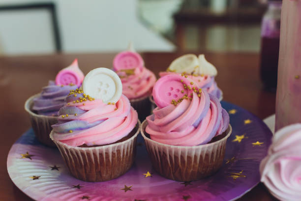 istock Tasty cupcakes on a white wooden table. 1172084771