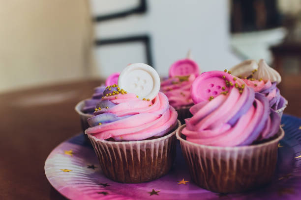 istock Tasty cupcakes on a white wooden table. 1172084774