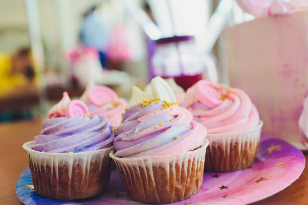 istock Tasty cupcakes on a white wooden table. 1172084780