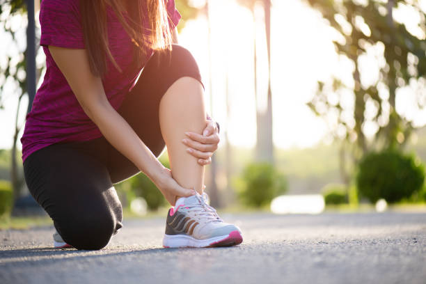 istock Ankle sprained. Young woman suffering from an ankle injury while exercising and running. Healthcare and sport concept. 1172096547