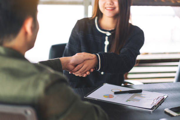 istock two businesspeople shaking hands in a meeting 1172101427