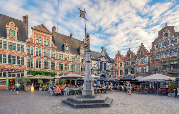 Old Market Square, Ghent, Belgium. Ghent is a port city at the confluence of the Leie and Scheldt rivers and a municipality in the Flemish Region of Belgium. Local people and tourists are enjoying in cafes and restaurants.